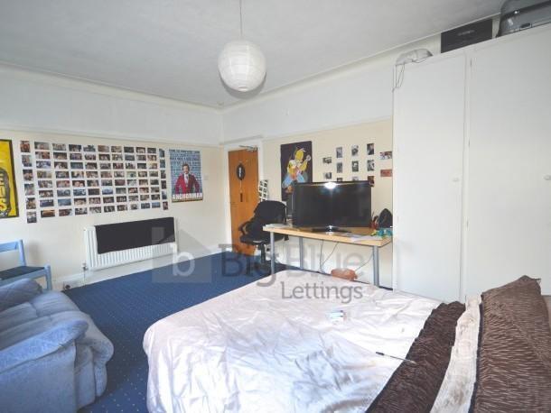 Spacious and well-lit master bedroom featuring ...