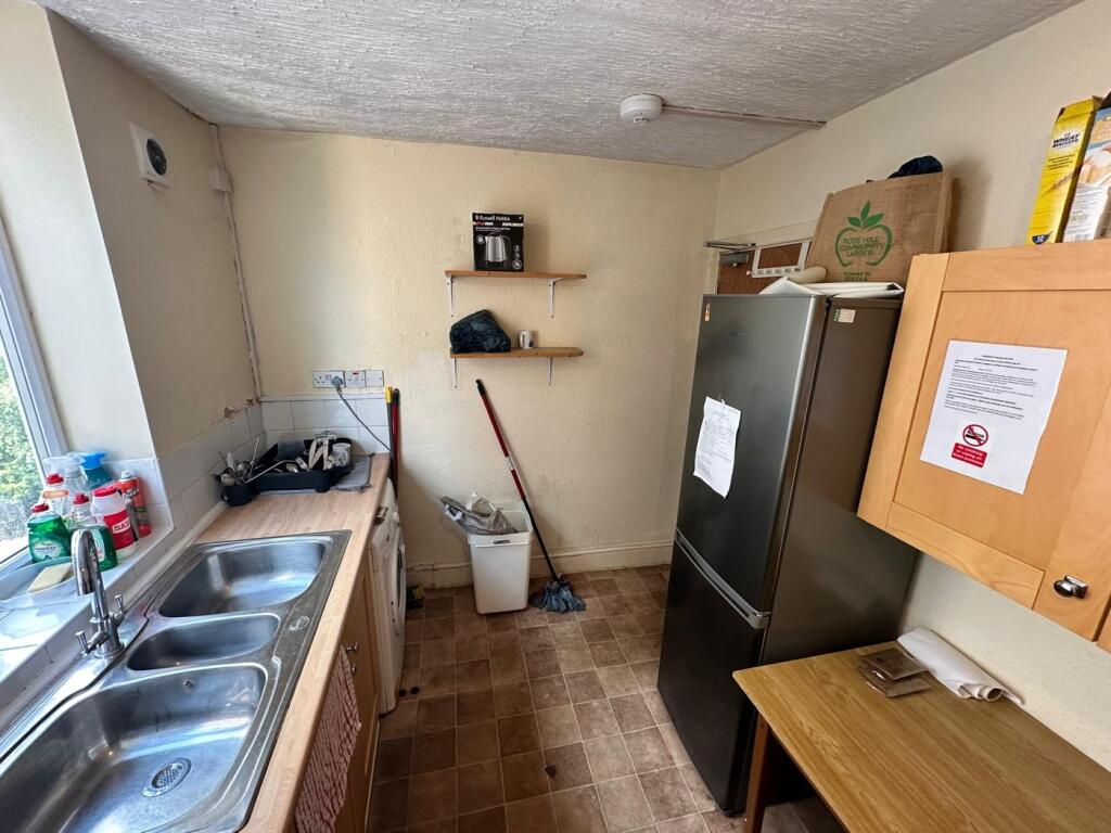 A functional kitchenette with ample space for c...