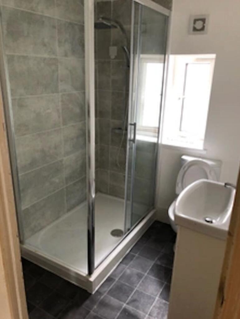 Bright and modern bathroom featuring a spacious...