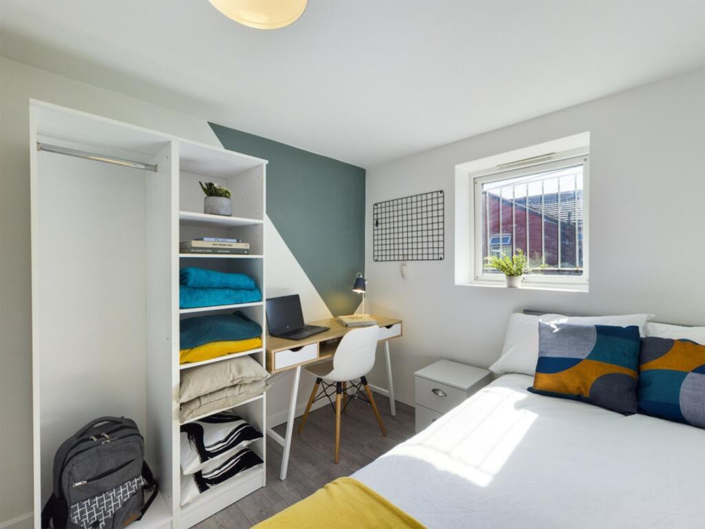 A bright and stylish double bedroom featuring m...
