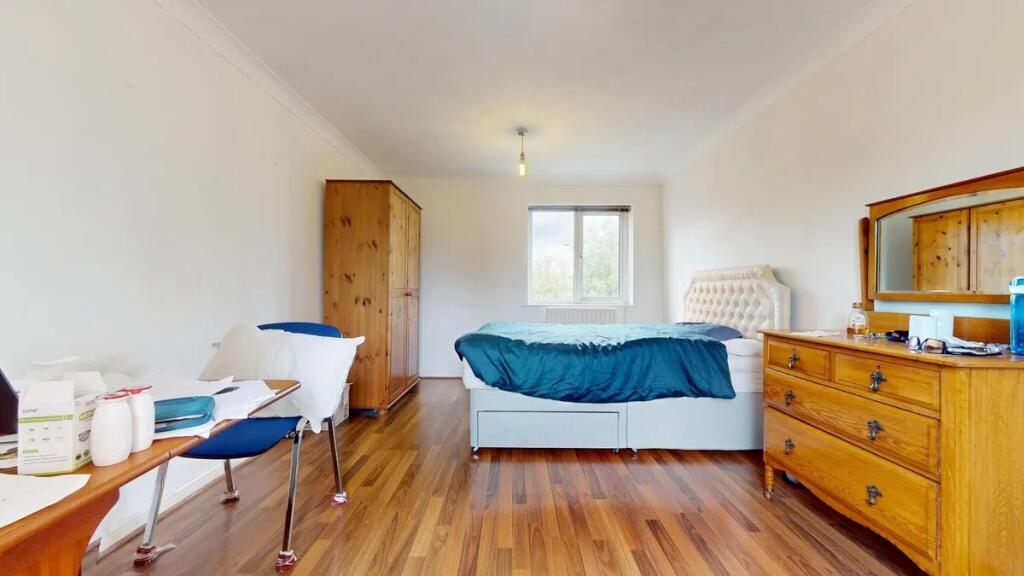 Bright double bedroom featuring a comfortable b...