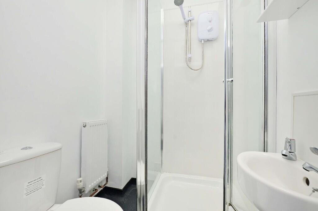 A clean and modern bathroom featuring a shower ...