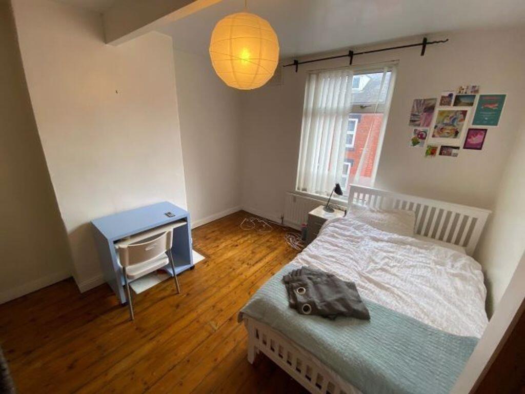 Bright, neatly presented bedroom with a comfort...