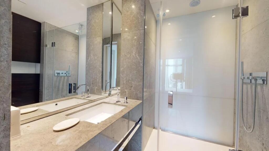 A modern and sleek bathroom suite featuring a l...
