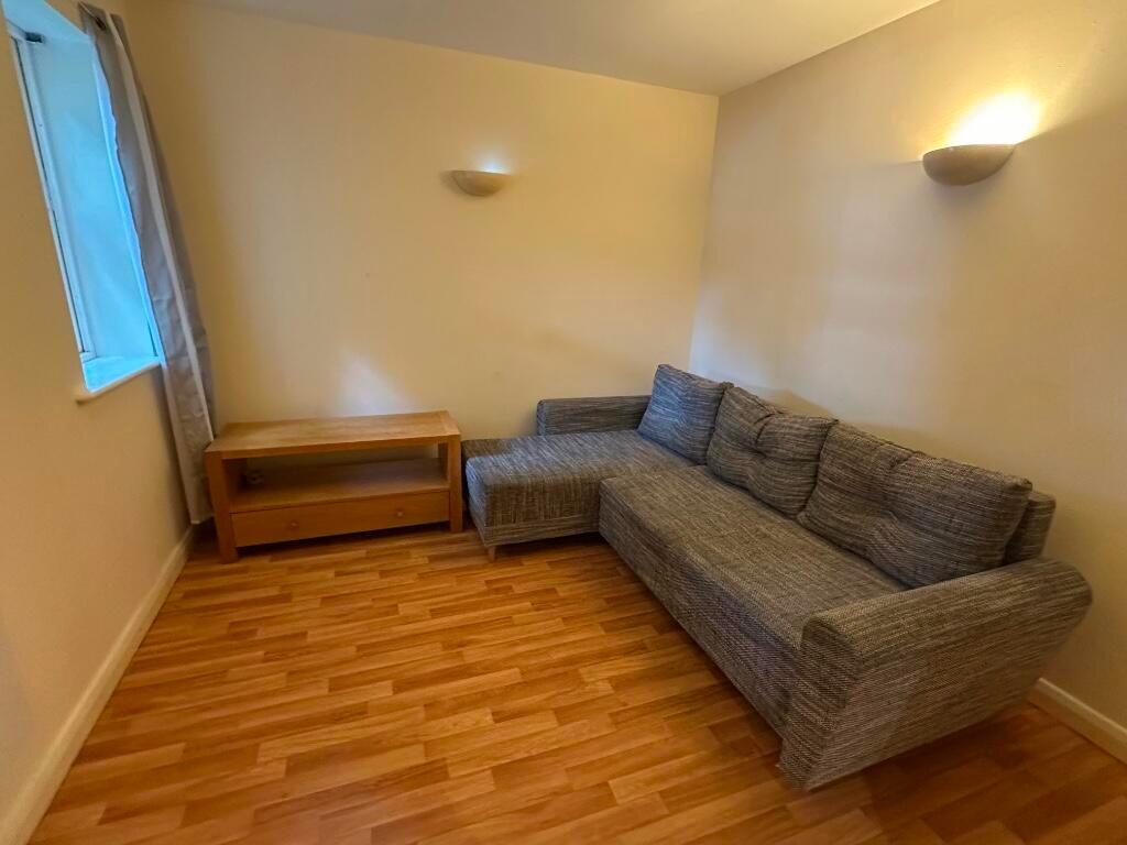 A cozy living room featuring a comfortable grey...