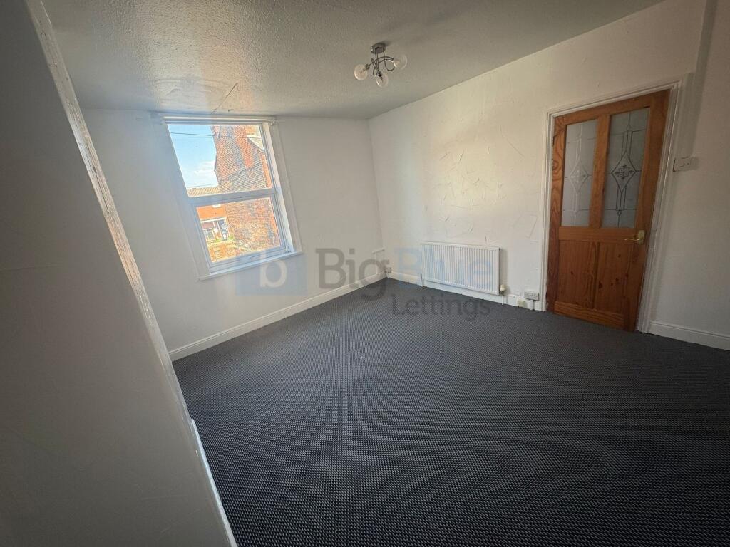 A bright and spacious living room featuring lar...