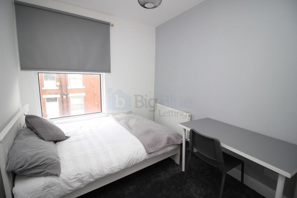 A neat and modern double bedroom featuring a co...