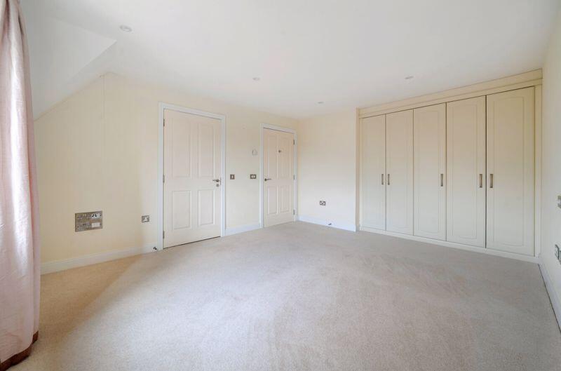 Bedroom with fitted wardrobes and ens...