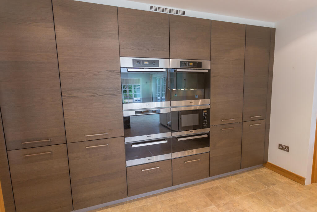 Integrated appliances including steamer
