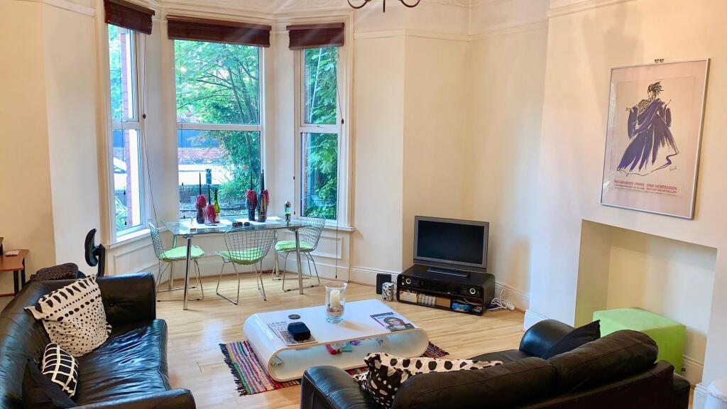 A bright and inviting living room featuring lar...