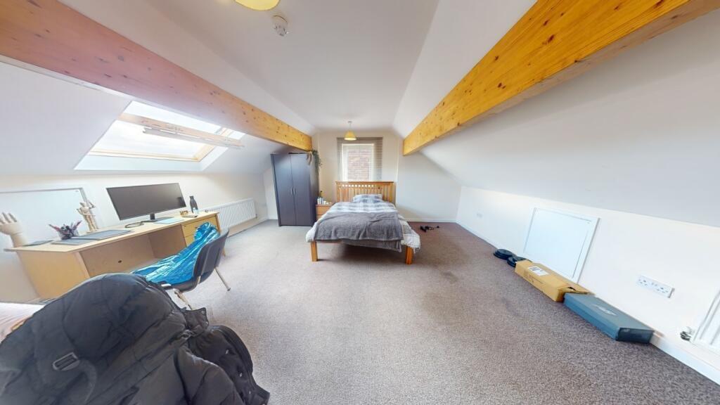 Spacious master bedroom featuring a comfortable...