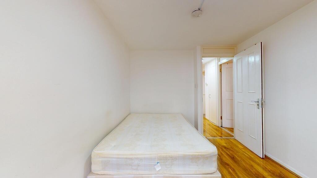 A spacious bedroom featuring a well-maintained ...