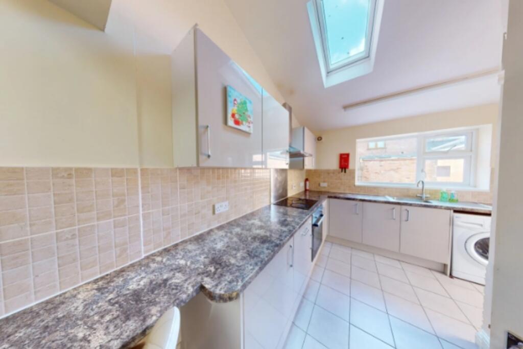 A modern and sleek kitchen featuring ample coun...