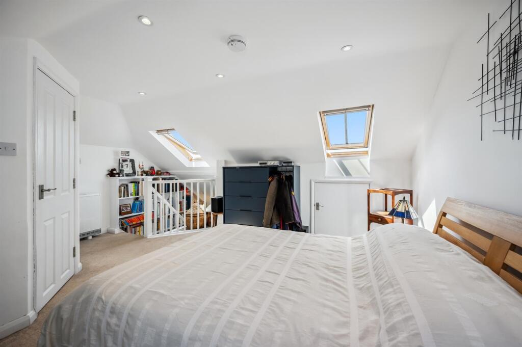 Bedroom Three towards stairs and fitted bookcase.j