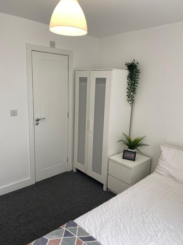 This inviting double bedroom features a bright ...
