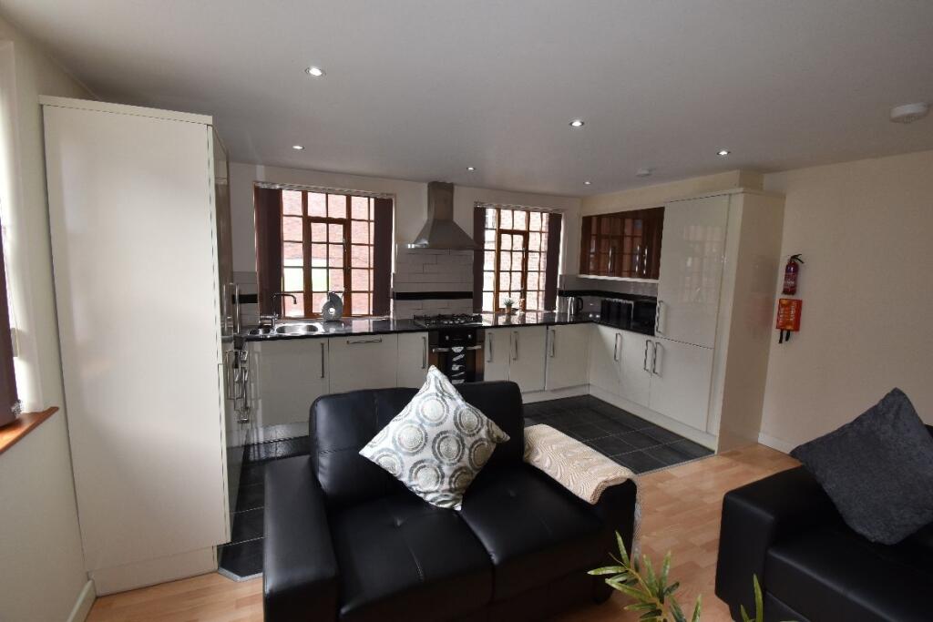A modern living room with comfortable black sof...