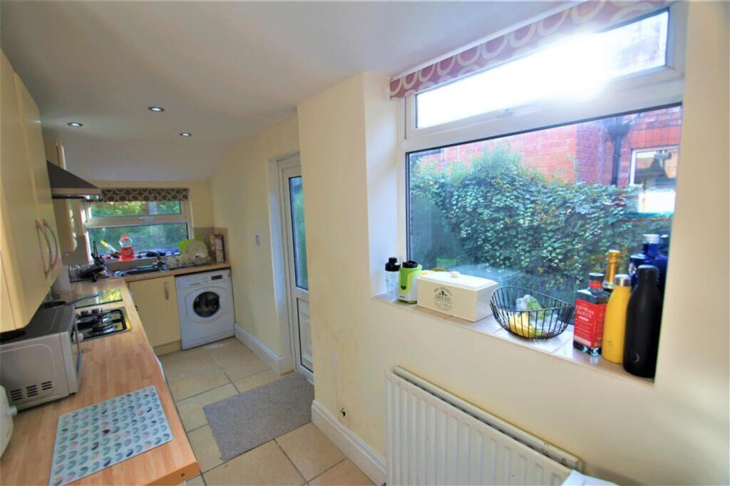 A bright and inviting kitchen featuring ample s...