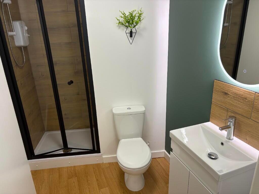 Bright and modern bathroom featuring a walk-in ...
