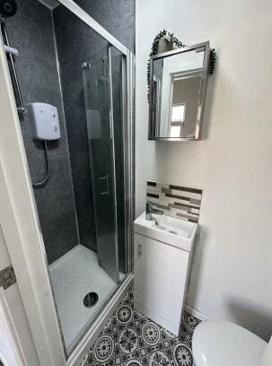 Bright and modern bathroom featuring a sleek gl...