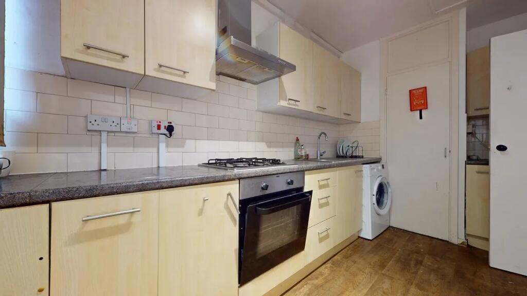Bright kitchen featuring light wood cabinetry, ...