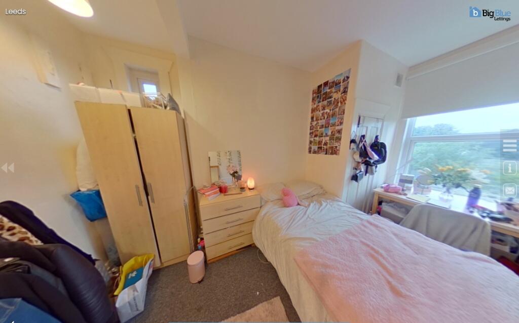 Bright and cozy single bedroom featuring a larg...