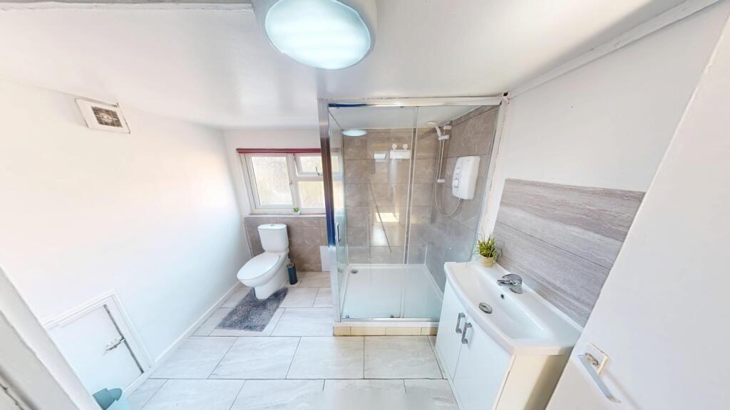 Bright and modern bathroom featuring a spacious...