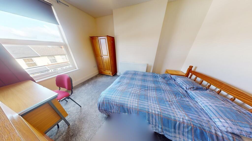 A bright and inviting double bedroom featuring ...