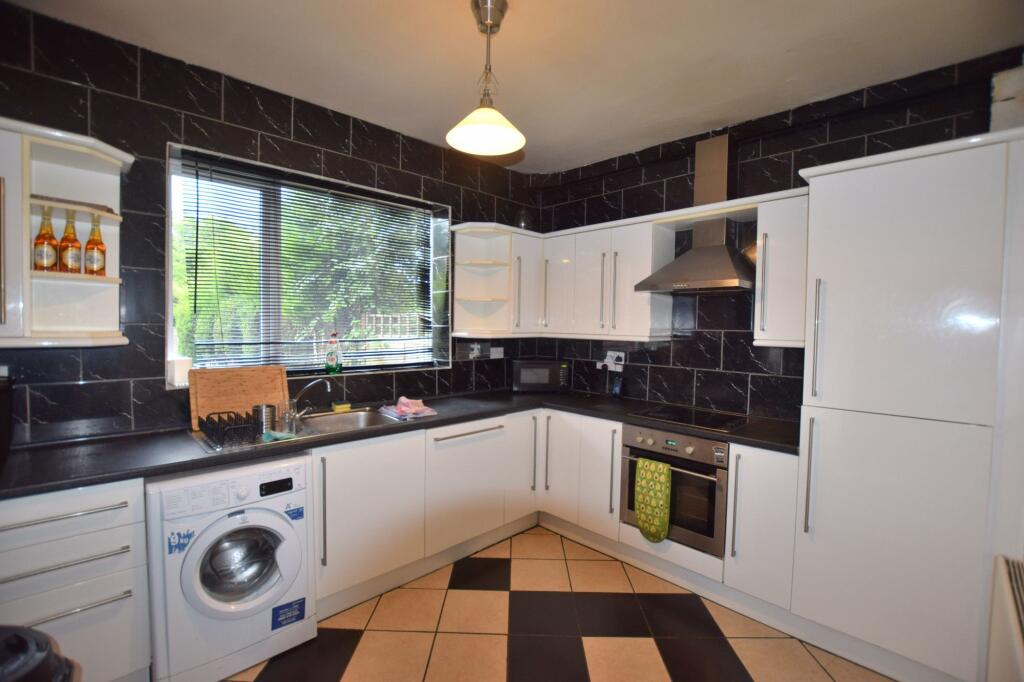 Bright and modern kitchen featuring sleek white...