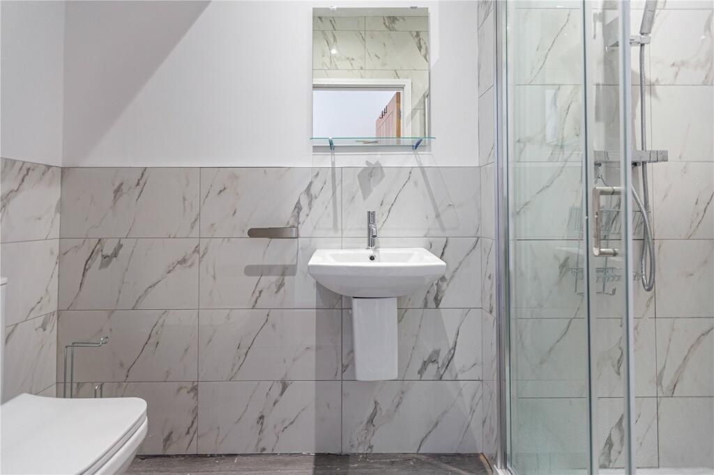 Bright and modern bathroom suite featuring eleg...