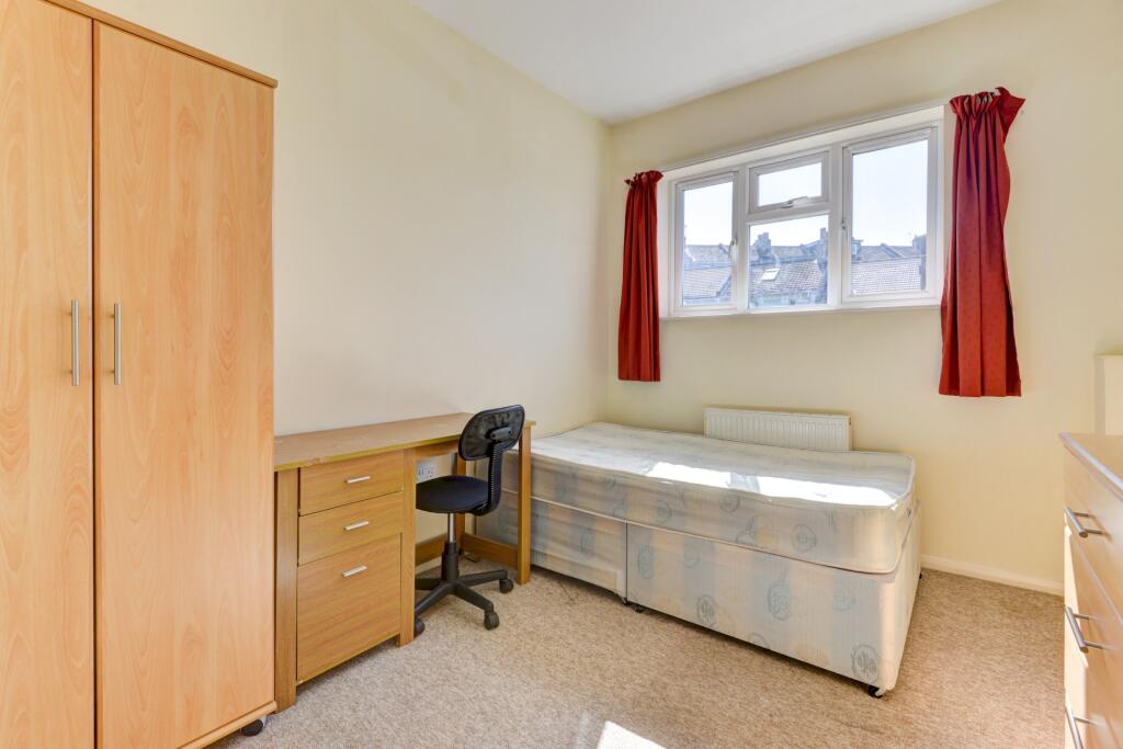 Bright and neat single bedroom featuring a comf...