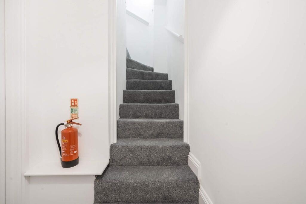 A well-maintained staircase featuring clean, pl...