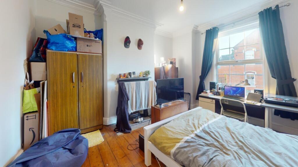 A cozy double bedroom featuring ample natural l...