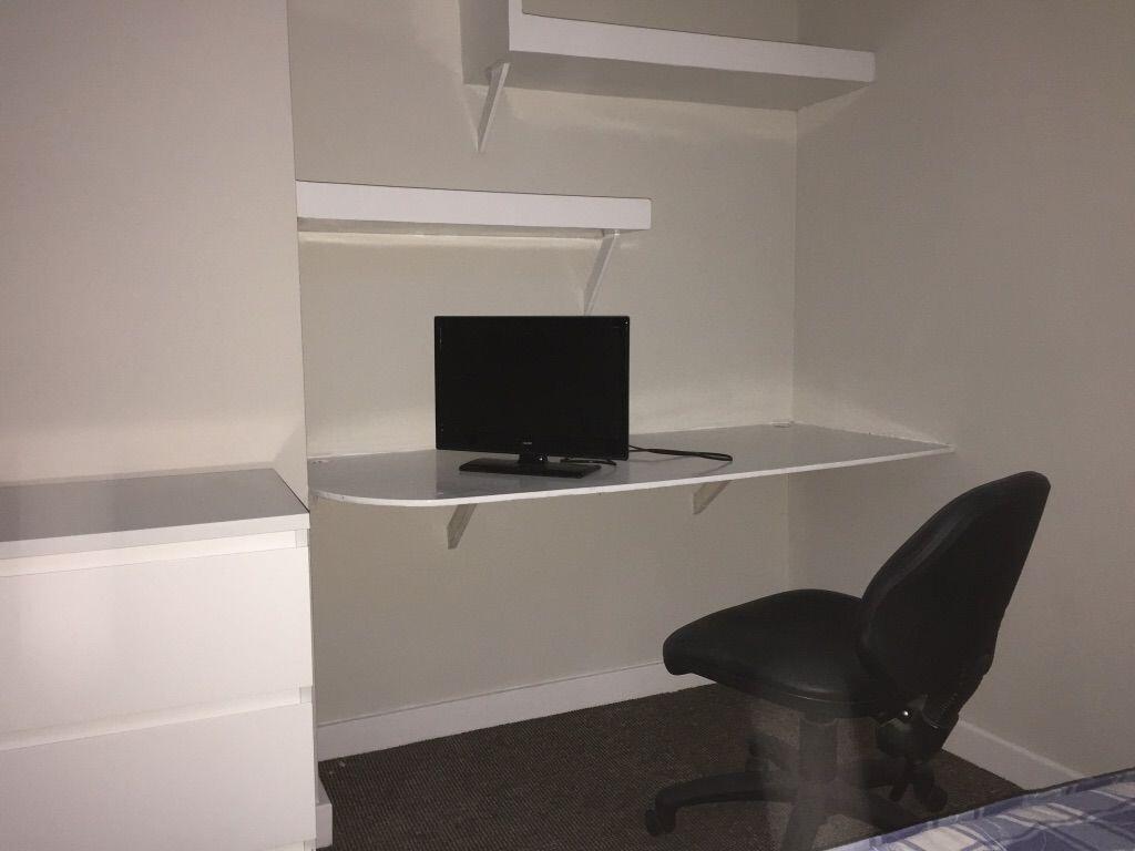 Compact bedroom workspace with a built-in wall ...