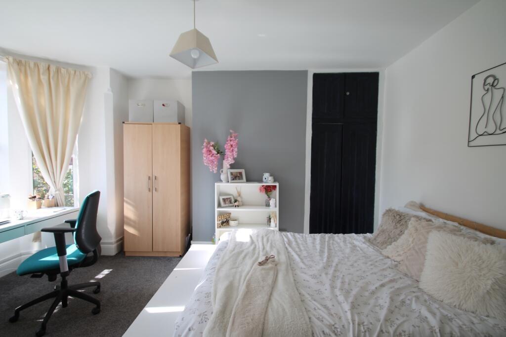 A bright and airy master bedroom with a comfort...