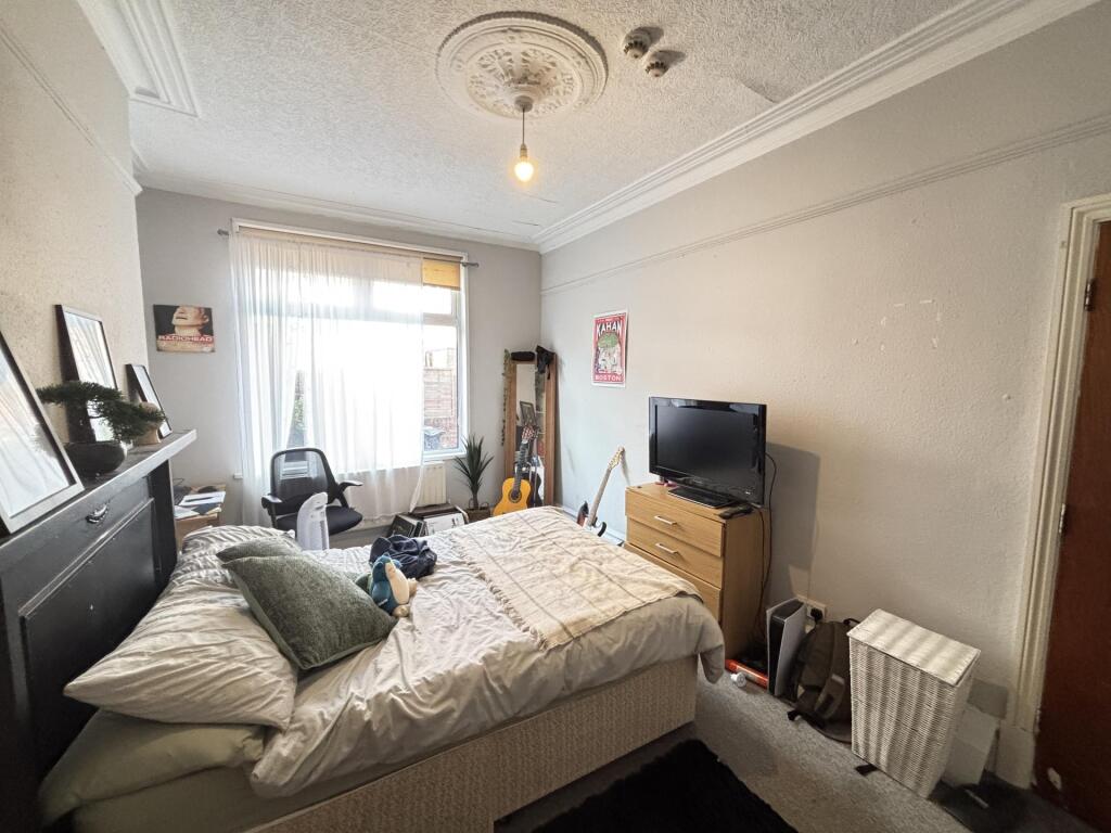 A cozy bedroom featuring a double bed, bedside ...