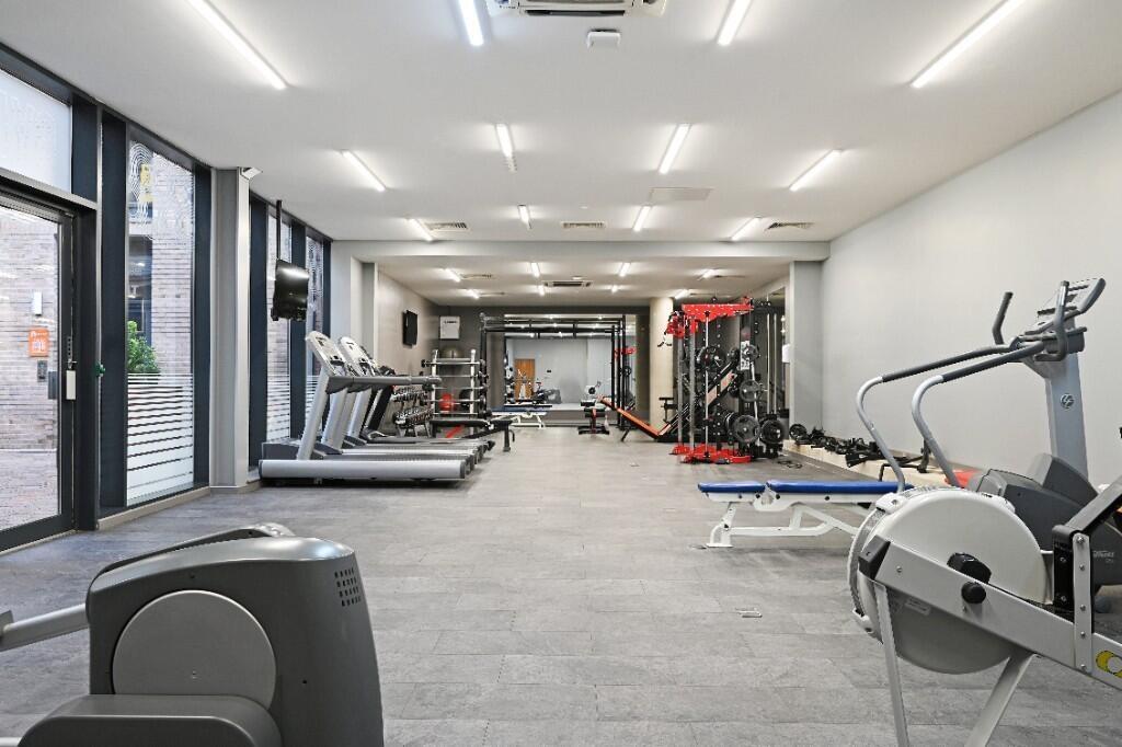 A modern, well-equipped gym with a spacious lay...