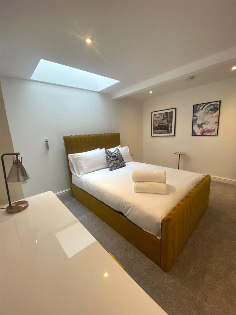 Bright and modern double bedroom featuring a co...