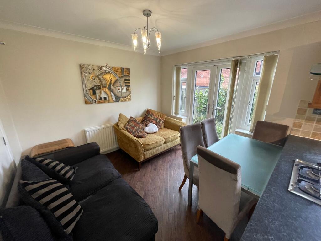 A welcoming living room filled with natural lig...
