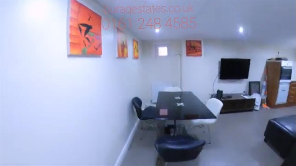 A modern communal lounge featuring a sleek blac...