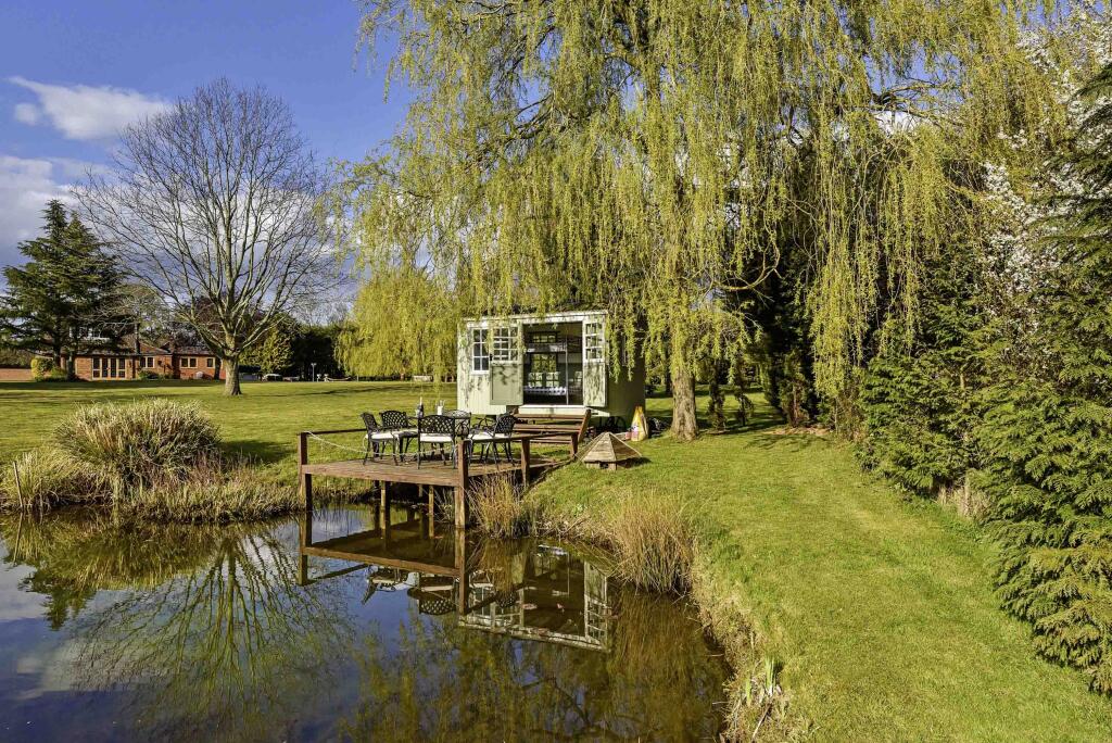 pond with shepherds hut