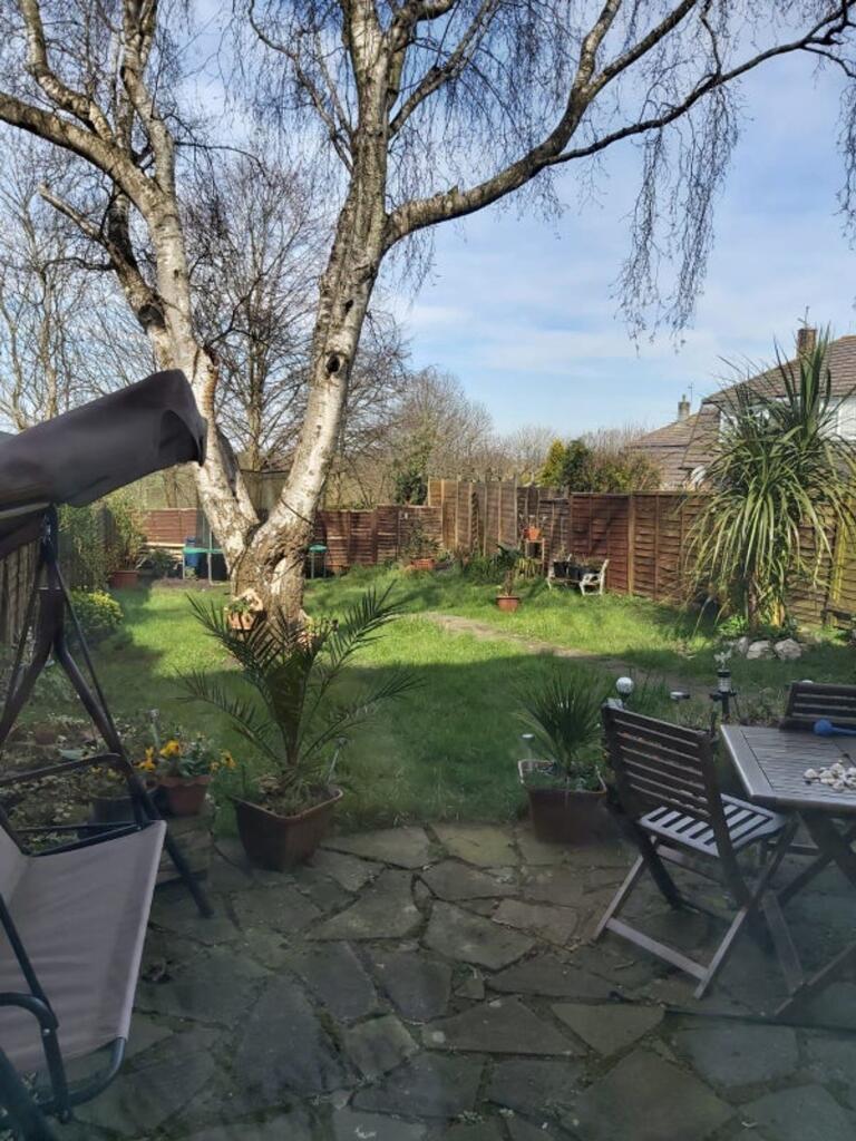 A beautiful garden space featuring lush greener...