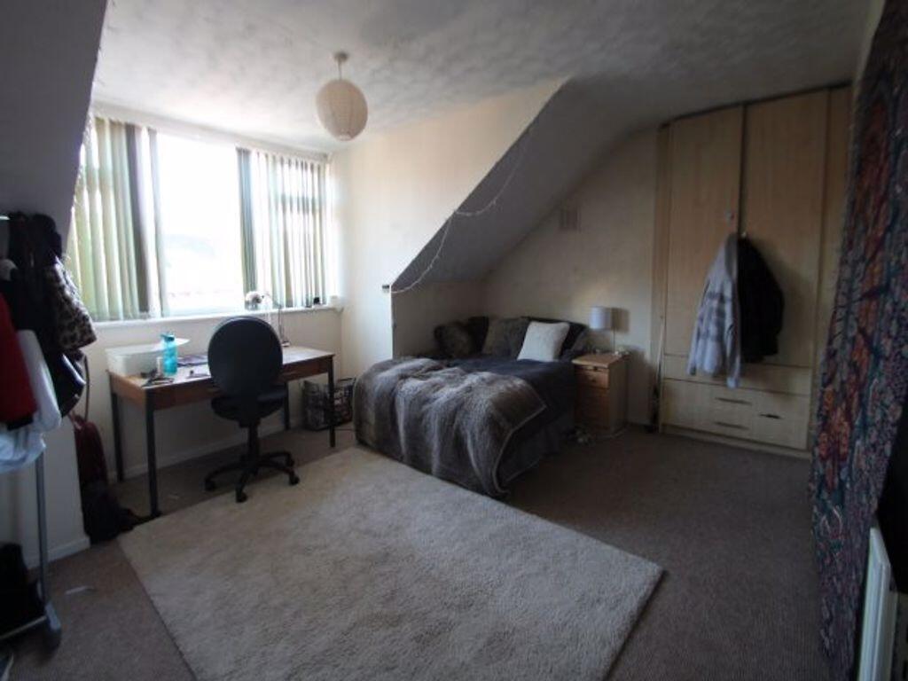 A cozy master bedroom featuring a comfortable d...