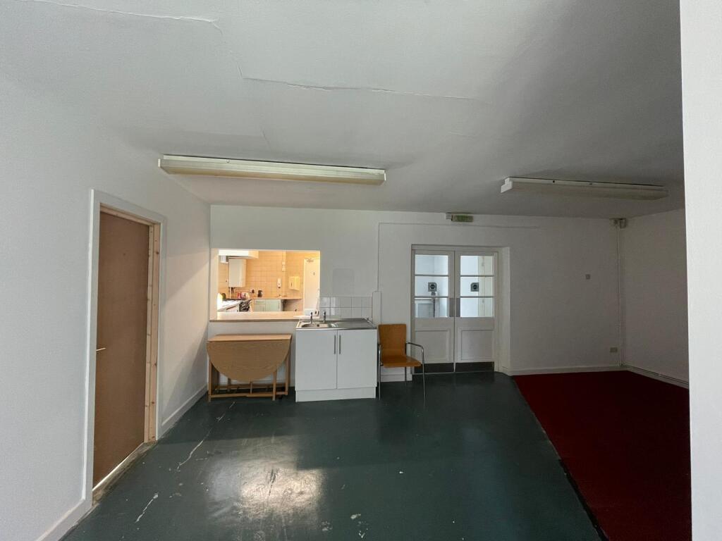 A simple communal lounge area featuring a small...