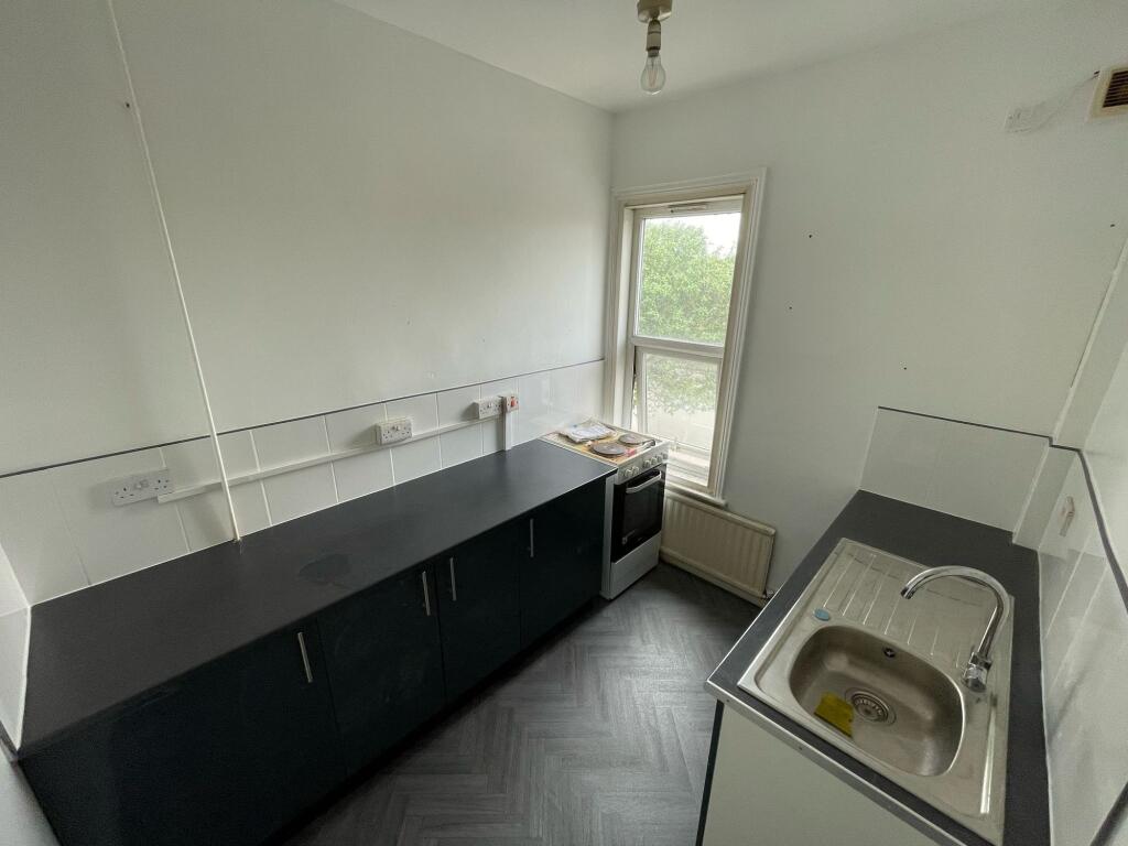 Bright kitchen featuring clean countertops, a m...