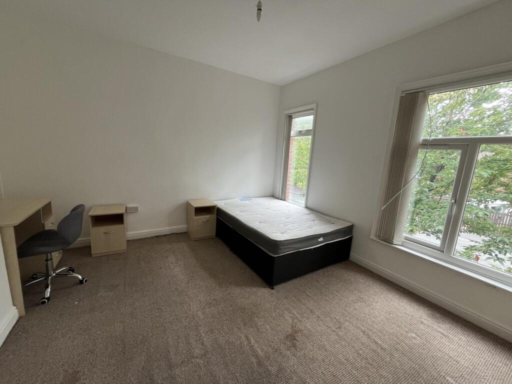 A bright and spacious double bedroom featuring ...