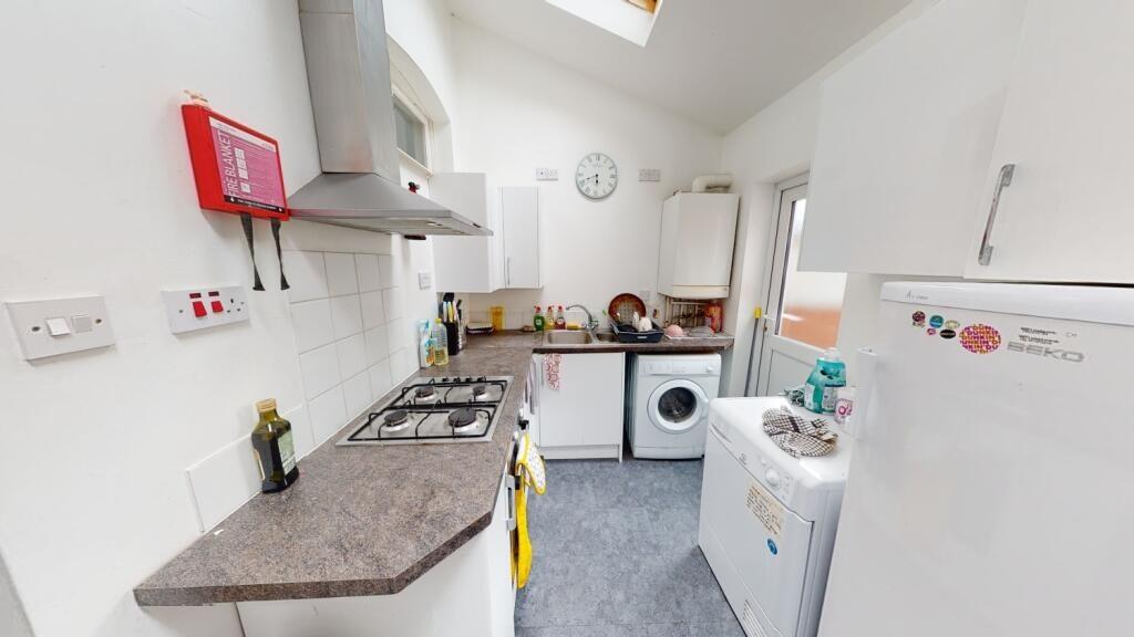 Bright and tidy kitchen featuring modern applia...