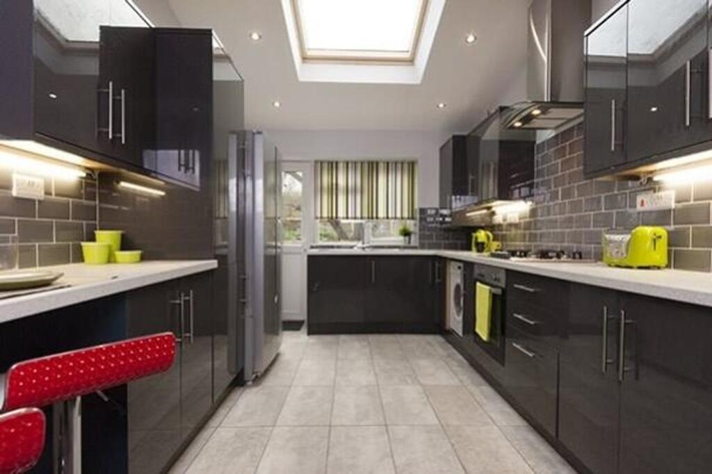 A modern and spacious kitchen with plenty of na...