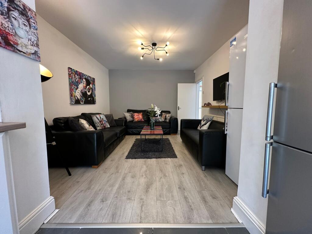 Spacious and modern living room featuring comfo...