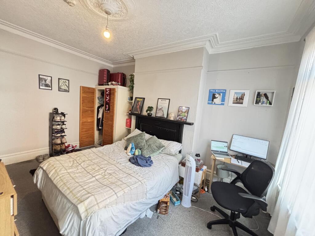Bright and spacious master bedroom featuring a ...