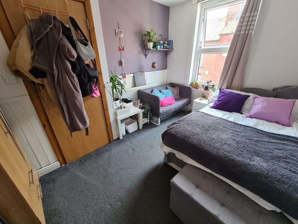 A cozy single bedroom featuring a comfortable b...